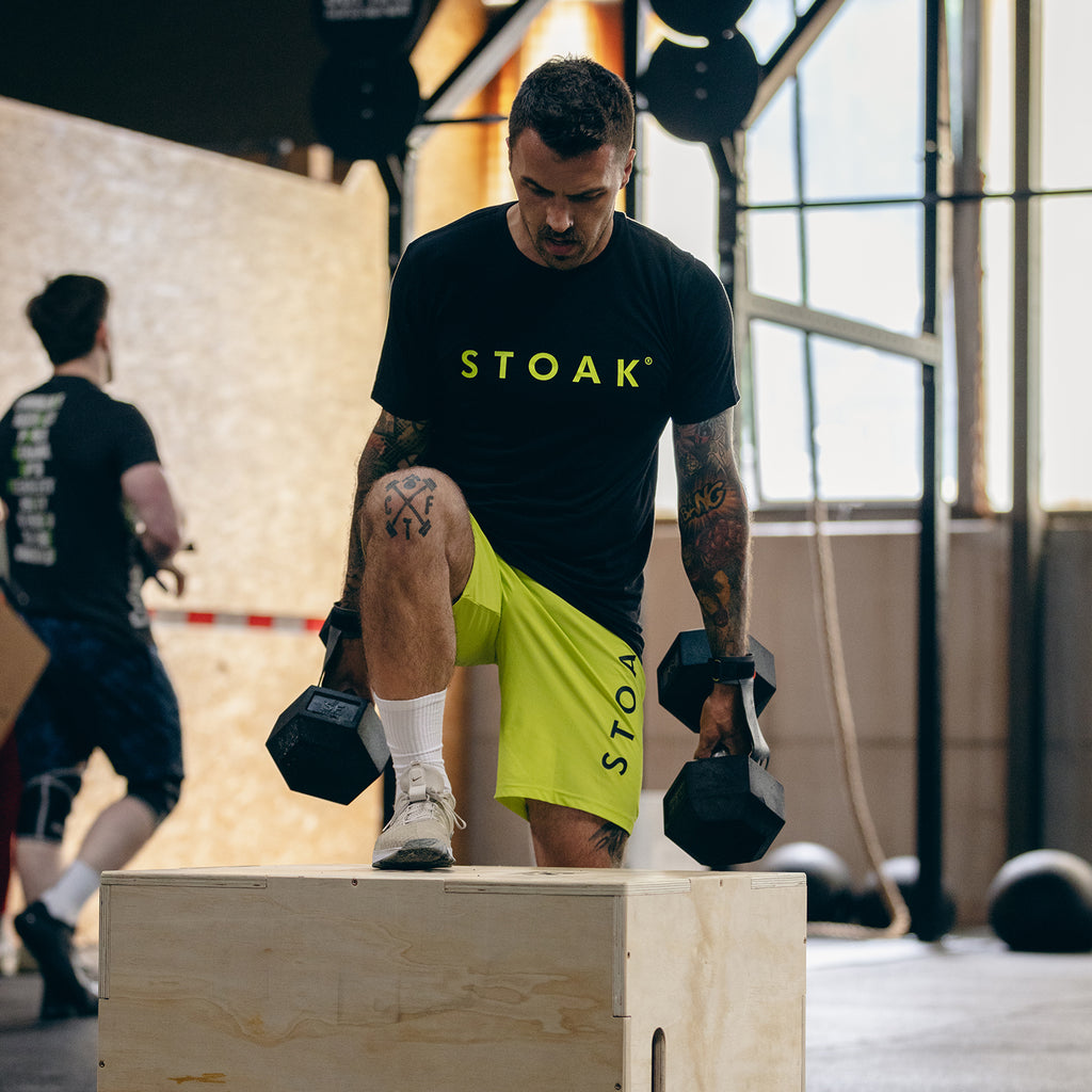 STOAK Men's Neon Yellow Performance Shorts in action step