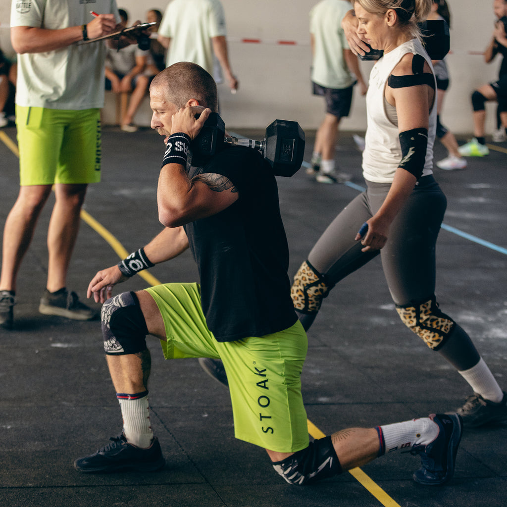 STOAK Men's Neon Yellow Performance Shorts in action lunges